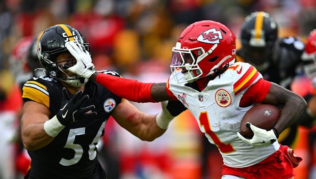 PITTSBURGH, PENNSYLVANIA - DECEMBER 25: Xavier Worthy #1 of the Kansas City Chiefs stiff arms Alex Highsmith #56 of the Pittsburgh Steelers during the third quarter at Acrisure Stadium on December 25, 2024 in Pittsburgh, Pennsylvania. (Photo by Joe Sargent/Getty Images)